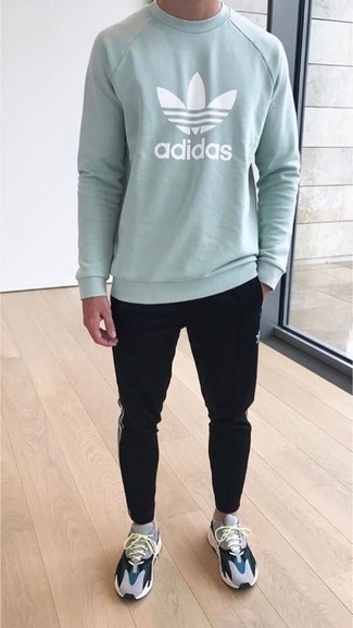 Mint Sweatshirt Outfits For Men: This bold casual combination of a mint sweatshirt and black sweatpants is super easy to throw together without a second thought, helping you look amazing and prepared for anything without spending too much time rummaging through your wardrobe. You can get a little creative with shoes and complement your outfit with a pair of grey athletic shoes.