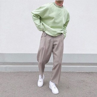 Mint Sweatshirt Outfits For Men: A mint sweatshirt and grey chinos have become must-have casual styles for most men. A pair of white leather low top sneakers complements this look quite nicely.