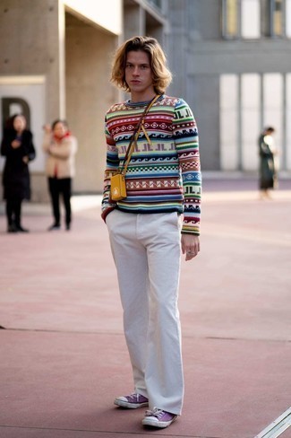 Multi colored Print Crew-neck Sweater Outfits For Men: A multi colored print crew-neck sweater and white corduroy chinos are among the fundamental elements in any gentleman's well-coordinated casual closet. A pair of violet canvas low top sneakers integrates smoothly within a myriad of ensembles.