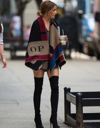 For a look that brings function and fashion, pair a multi colored check poncho with brown check wool shorts. Black suede over the knee boots are guaranteed to inject a dash of sophistication into your outfit.