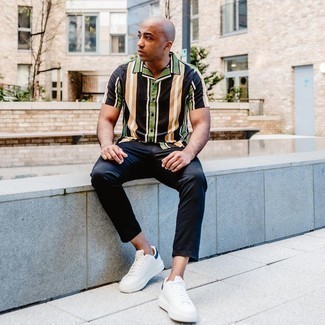 White and Navy Leather Low Top Sneakers Outfits For Men: A multi colored vertical striped short sleeve shirt looks so great when paired with navy chinos. A pair of white and navy leather low top sneakers is a goofproof footwear style that's also full of personality.
