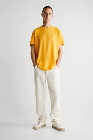 Mustard Crew-neck T-shirt Outfits For Men: This pairing of a mustard crew-neck t-shirt and white jeans spells casual cool and stylish functionality. White canvas low top sneakers are a wonderful idea to finish your look.