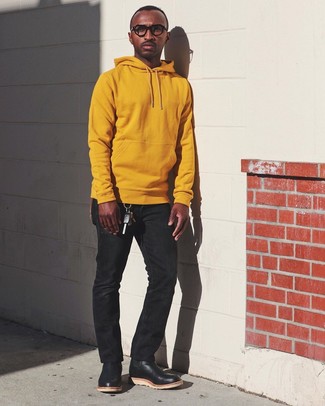 Orange Hoodie Outfits For Men: An orange hoodie and black jeans are an essential combination for many stylish gentlemen. Black leather chelsea boots will give a hint of elegance to an otherwise mostly casual ensemble.