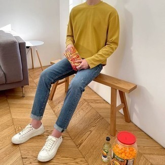 Jeans Outfits For Men: For a casual look, marry a mustard long sleeve t-shirt with jeans — these two items go really well together. The whole outfit comes together when you complement your outfit with a pair of white canvas low top sneakers.