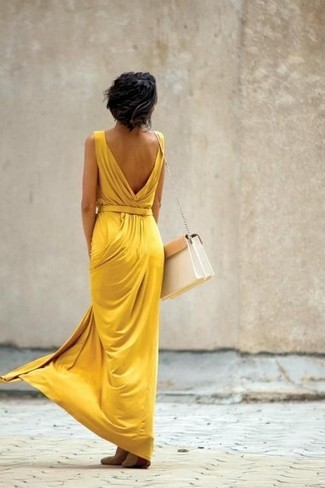 Rock a mustard maxi dress to assemble an everyday ensemble that's full of charisma and character. A pair of beige suede ballerina shoes is a great pick to finish this ensemble.