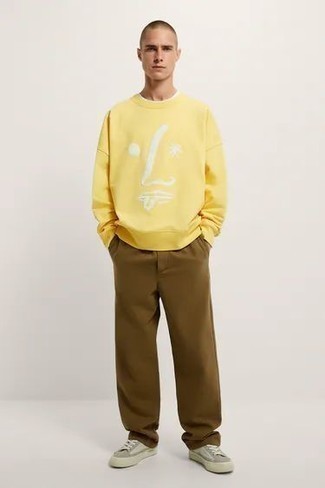 Yellow Sweatshirt Outfits For Men: One of the most popular ways for a man to style out a yellow sweatshirt is to wear it with brown chinos for a casual look. A pair of grey canvas low top sneakers looks right at home with this outfit.