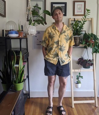 Navy Shorts Outfits For Men: Pair a mustard print short sleeve shirt with navy shorts for a casually edgy and fashionable look. Bring a fresh twist to an otherwise dressy look by slipping into dark brown leather sandals.