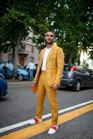Yellow Suit Outfits: As you can see here, it doesn't require that much effort for a man to look on-trend. Consider teaming a yellow suit with a white crew-neck t-shirt and you'll look incredibly stylish. Take an otherwise classic look in a more laid-back direction by rounding off with white and red canvas low top sneakers.