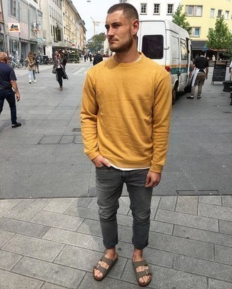 Yellow Sweatshirt Outfits For Men: Rock a yellow sweatshirt with charcoal jeans for both stylish and easy-to-create getup. If you want to immediately play down this ensemble with a pair of shoes, introduce a pair of olive leather sandals to the equation.