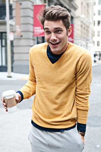 Mustard V-neck Sweater Outfits For Men: This combo of a mustard v-neck sweater and grey sweatpants is super easy to put together and so comfortable to rock as well!