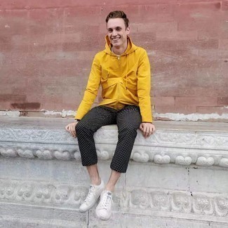 Mustard Windbreaker Outfits For Men: This look with a mustard windbreaker and black polka dot chinos isn't super hard to assemble and is easy to adapt. If you're wondering how to finish off, a pair of white canvas low top sneakers is a nice idea.
