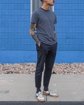 Navy Horizontal Striped Crew-neck T-shirt Outfits For Men: Show off your chops in menswear styling by opting for this casual combination of a navy horizontal striped crew-neck t-shirt and navy chinos. The whole ensemble comes together quite nicely when you finish with white and navy leather low top sneakers.
