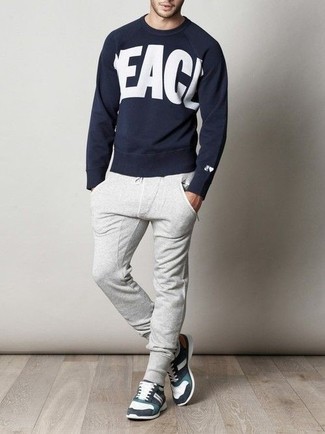 Charcoal Sweatpants Outfits For Men: To put together a laid-back getup with a street style finish, wear a navy and white print crew-neck sweater with charcoal sweatpants. And if you want to effortlessly play down this outfit with a pair of shoes, why not complete this getup with white and black athletic shoes?