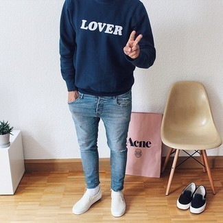 Navy and White Print Sweatshirt Outfits For Men: A navy and white print sweatshirt looks so cool when worn with light blue ripped skinny jeans in a casual look. Wondering how to finish this outfit? Rock white canvas slip-on sneakers to kick it up a notch.