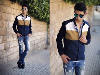 Navy and White Varsity Jacket Outfits For Men: A navy and white varsity jacket and blue ripped jeans are must-have essentials if you're figuring out an off-duty closet that matches up to the highest sartorial standards. If you want to instantly elevate this getup with a pair of shoes, introduce black leather casual boots to the equation.