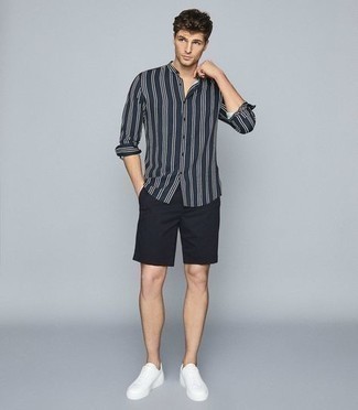 Navy Vertical Striped Long Sleeve Shirt Outfits For Men: This ensemble with a navy vertical striped long sleeve shirt and black shorts isn't so hard to score and is easy to adapt. White canvas low top sneakers make this look whole.