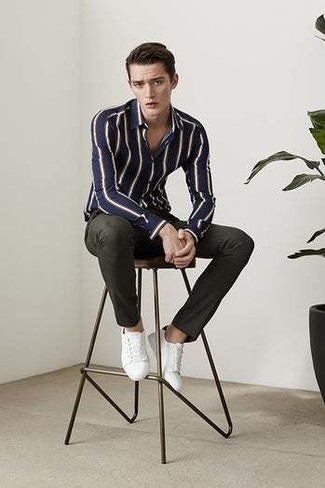 White and Black Canvas Low Top Sneakers Outfits For Men: One of the most popular ways for a man to style a navy and white vertical striped long sleeve shirt is to marry it with dark green chinos in a laid-back look. Introduce white and black canvas low top sneakers to the mix and ta-da: the look is complete.