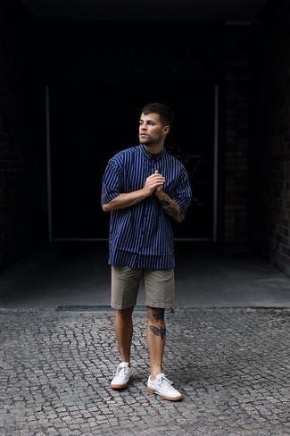 Blue Vertical Striped Short Sleeve Shirt Outfits For Men: If you would like take your casual look to a new height, try pairing a blue vertical striped short sleeve shirt with grey shorts. White canvas low top sneakers are a fitting pick here.