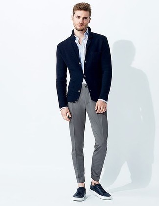 Navy Leather Low Top Sneakers Outfits For Men: Wear a navy knit blazer and grey chinos to ooze masculine sophistication and polish. To inject a more relaxed aesthetic into your outfit, complement this outfit with a pair of navy leather low top sneakers.