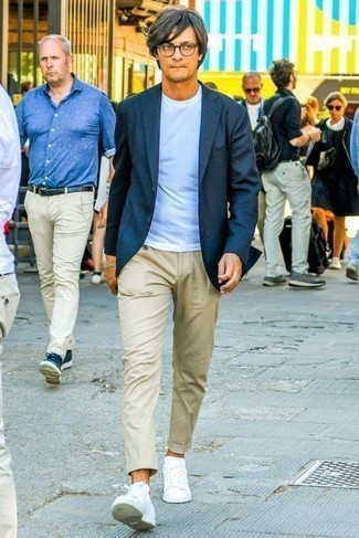 White Low Top Sneakers Outfits For Men: This combination of a navy blazer and beige chinos crosses the divide between formal and relaxed. For something more on the off-duty end to complement your getup, add white low top sneakers to the mix.