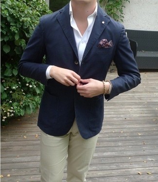 Go for a pared down but on-trend getup marrying a navy blazer and beige chinos.