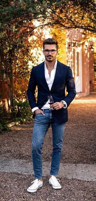 White Dress Shirt with Navy Jeans Outfits For Men: Kick up your sartorial game by opting for this combination of a white dress shirt and navy jeans. Complement this outfit with white canvas low top sneakers to keep the outfit fresh.