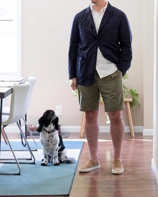 Slip-on Sneakers Outfits For Men: This ensemble with a navy cotton blazer and olive shorts isn't hard to pull off and easy to change. A pair of slip-on sneakers instantly boosts the style factor of this outfit.