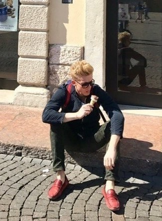 Alexander Zaytsev wearing Navy Bomber Jacket, Dark Green Jeans, Red Leather Loafers, Red Backpack