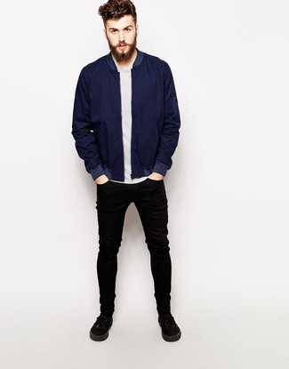 Black Plimsolls Outfits For Men: A navy bomber jacket and black skinny jeans are both versatile menswear must-haves that will integrate wonderfully within your day-to-day off-duty wardrobe. Add a pair of black plimsolls to the mix for some extra elegance.