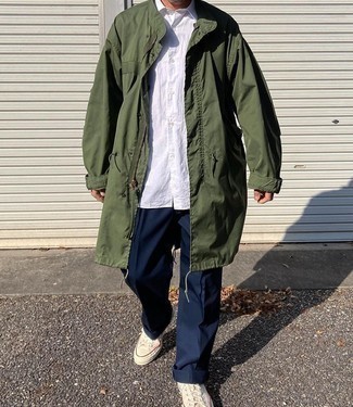 Men's White Canvas Low Top Sneakers, Navy Chinos, White Short Sleeve Shirt, Olive Raincoat