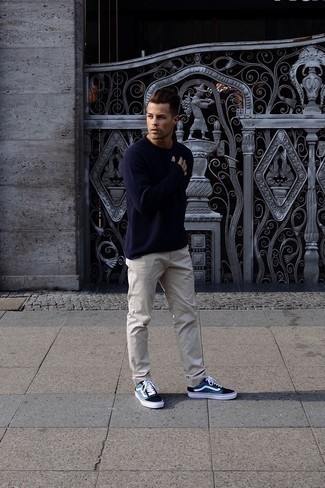 Navy Crew-neck Sweater Outfits For Men: Such pieces as a navy crew-neck sweater and beige chinos are an easy way to infuse subtle dapperness into your day-to-day wardrobe. To inject a more relaxed aesthetic into this look, introduce navy and white canvas low top sneakers to this getup.