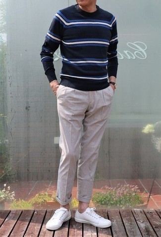 Navy Horizontal Striped Crew-neck Sweater Outfits For Men: A navy horizontal striped crew-neck sweater and beige vertical striped chinos are the perfect way to inject played down dapperness into your daily casual arsenal. When it comes to footwear, rock a pair of white canvas low top sneakers.