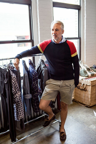 A navy crew-neck sweater and beige shorts make for the perfect base for a ton of getups. Make dark brown suede driving shoes your footwear choice for extra style points.