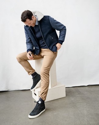 Charcoal High Top Sneakers Outfits For Men: Demonstrate that nobody does casual like you in a navy crew-neck sweater and beige chinos. For a more laid-back take, why not complement your ensemble with a pair of charcoal high top sneakers?