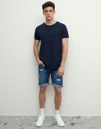 Navy Ripped Denim Shorts Outfits For Men: This casual combination of a navy crew-neck t-shirt and navy ripped denim shorts is super easy to pull together in next to no time, helping you look amazing and ready for anything without spending a ton of time digging through your wardrobe. Breathe a touch of refinement into your ensemble by rounding off with a pair of white leather low top sneakers.
