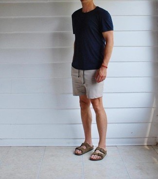 Suede Sandals Outfits For Men: This pairing of a navy crew-neck t-shirt and grey shorts is a safe bet for an effortlessly cool ensemble. On the fence about how to finish off? Introduce a pair of suede sandals to your look to switch things up.