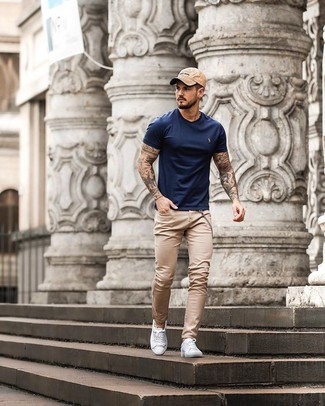 Khaki Jeans Outfits For Men: For a laid-back and cool ensemble, go for a navy crew-neck t-shirt and khaki jeans — these pieces fit perfectly well together. A pair of white canvas low top sneakers is a good option to round off your ensemble.