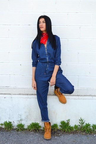 Navy Denim Jumpsuit Outfits: Opt for a navy denim jumpsuit for both chic and easy-to-style outfit. Our favorite of a countless number of ways to finish this outfit is a pair of tan suede lace-up flat boots.