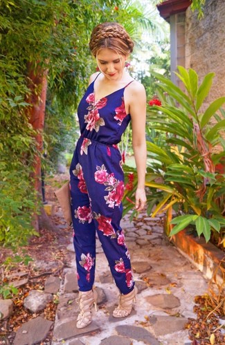 Women's Outfits 2022: The cool-girl casual style translates here to a navy floral jumpsuit. For a trendy hi/low mix, complete this look with beige leather heeled sandals.
