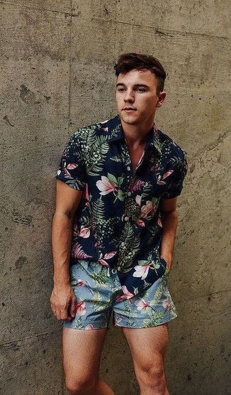 Navy and White Floral Shirt Outfits For Men: This casual combination of a navy and white floral shirt and light blue floral shorts comes to rescue when you need to look casually dapper but have no time.