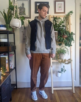 Grey Hoodie Outfits For Men: A grey hoodie and brown corduroy chinos worn together are a great match. You could perhaps get a little creative when it comes to shoes and complete this look with a pair of white and navy leather high top sneakers.