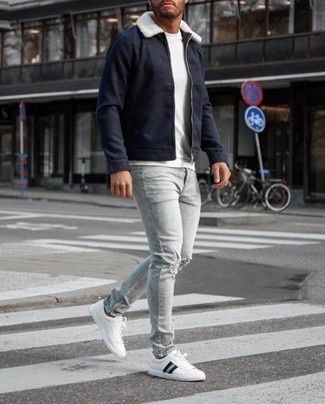 White and Black Low Top Sneakers with Harrington Jacket Outfits: This combination of a harrington jacket and grey ripped jeans is pulled together and yet it looks casual enough and ready for anything. Tap into some Idris Elba stylishness and class up your getup with white and black low top sneakers.