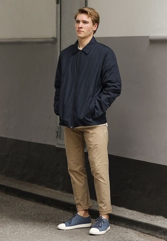 Navy Canvas Low Top Sneakers Outfits For Men: This casual combo of a navy harrington jacket and khaki chinos is very easy to pull together in no time, helping you look dapper and ready for anything without spending a ton of time searching through your closet. Bring a playful feel to your getup by rounding off with a pair of navy canvas low top sneakers.
