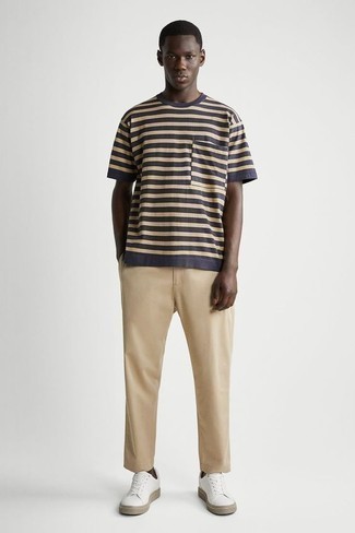White Canvas Low Top Sneakers Outfits For Men: This relaxed combination of a navy horizontal striped crew-neck t-shirt and khaki chinos is capable of taking on different moods depending on how you style it out. Look at how well this outfit goes with white canvas low top sneakers.