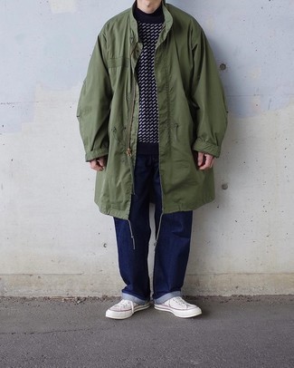 Men's White Canvas Low Top Sneakers, Navy Jeans, Navy and White Print Crew-neck Sweater, Olive Raincoat