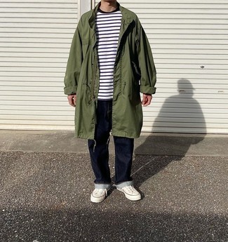 Men's White Canvas Low Top Sneakers, Navy Jeans, White and Navy Horizontal Striped Crew-neck T-shirt, Olive Raincoat