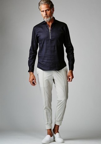 White Sweatpants Outfits For Men: Such essentials as a navy linen long sleeve shirt and white sweatpants are the ideal way to introduce effortless cool into your day-to-day casual lineup. If you need to effortlessly perk up your look with one item, why not add white canvas slip-on sneakers to the equation?