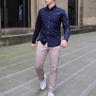 Navy and White Long Sleeve Shirt Outfits For Men: Who said you can't make a fashion statement with a laid-back outfit? Draw the attention in a navy and white long sleeve shirt and beige chinos. A trendy pair of white leather low top sneakers is the simplest way to add a confident kick to the ensemble.