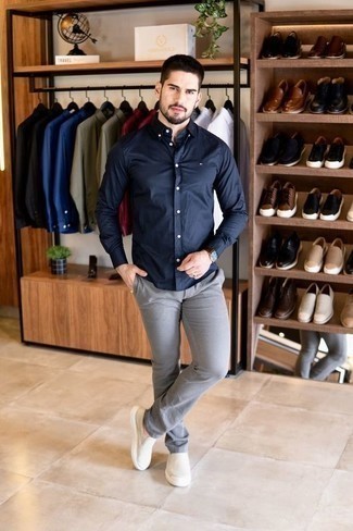 Navy Long Sleeve Shirt Outfits For Men: This pairing of a navy long sleeve shirt and grey chinos is ideal for weekend days. If not sure about what to wear in the shoe department, introduce beige canvas slip-on sneakers to the equation.