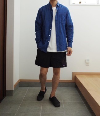 Black Sports Shorts Outfits For Men: A navy chambray long sleeve shirt and black sports shorts are a good ensemble to add to your day-to-day collection. Go off the beaten track and break up your look with a pair of black canvas slip-on sneakers.